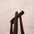 low angle view of cross with red garment